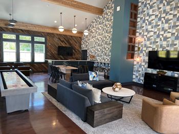 A living room with a pool table and a television.